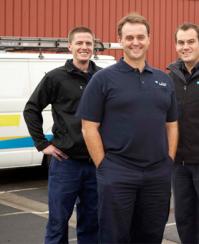 three of our Woodinville plumbers standing ready by their plumbing truck